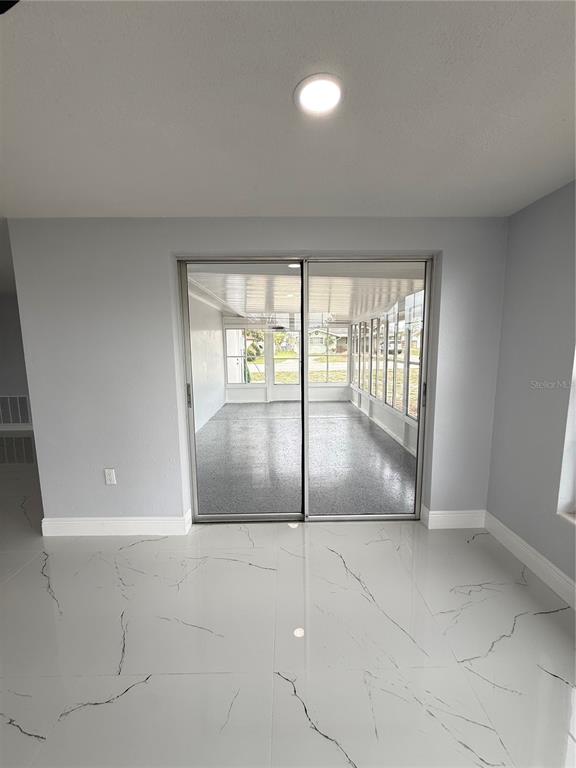 10433 Laburnum Drive Port Richey, FL 34668 - Photo 24 of 26 a view of an empty room and window