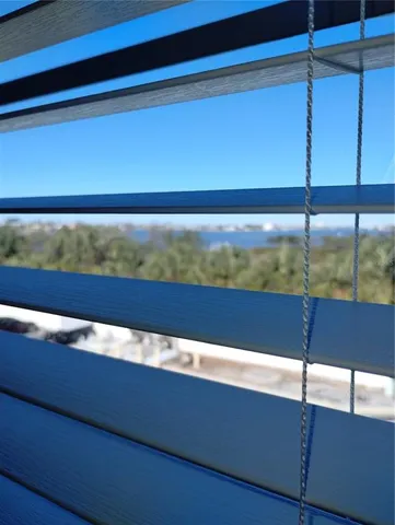 a view of a room with a ceiling fan and wooden floor