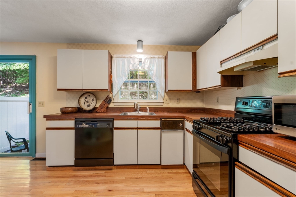 10 Apple Ridge Road, Unit 4 Maynard, MA 01754 - Photo 11 of 27 a kitchen with stainless steel appliances granite countertop a stove a sink and a microwave