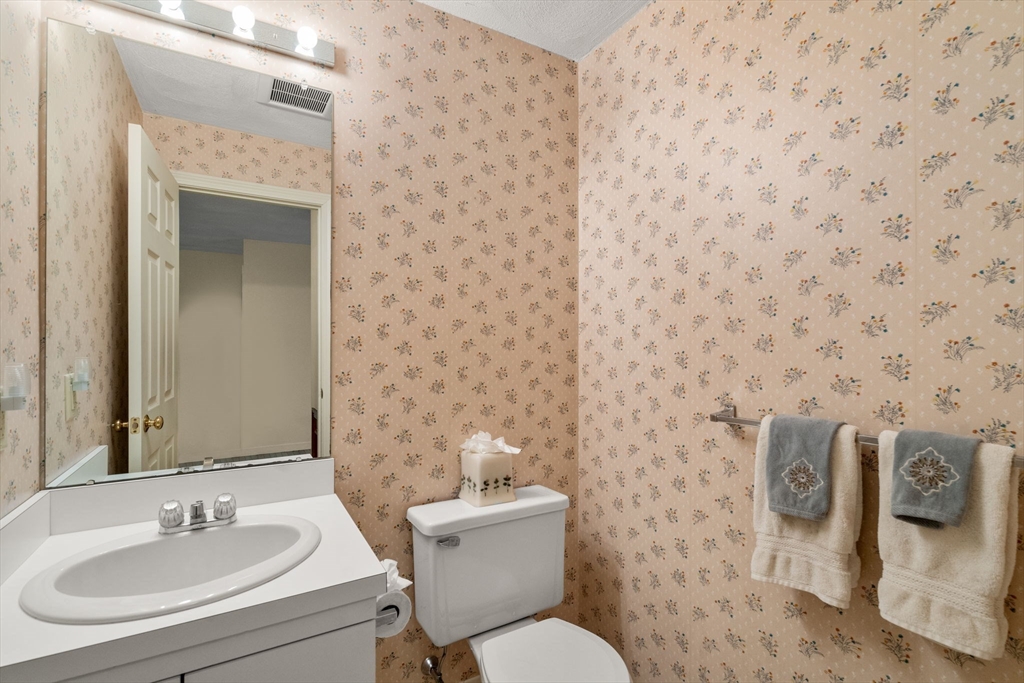 10 Apple Ridge Road, Unit 4 Maynard, MA 01754 - Photo 12 of 27 a bathroom with a toilet sink and mirror