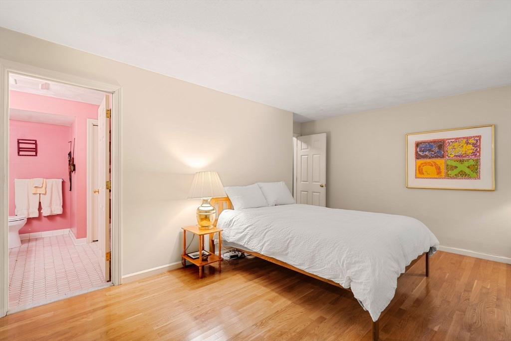 10 Apple Ridge Road, Unit 4 Maynard, MA 01754 - Photo 13 of 27 a bedroom with a bed and a lamp