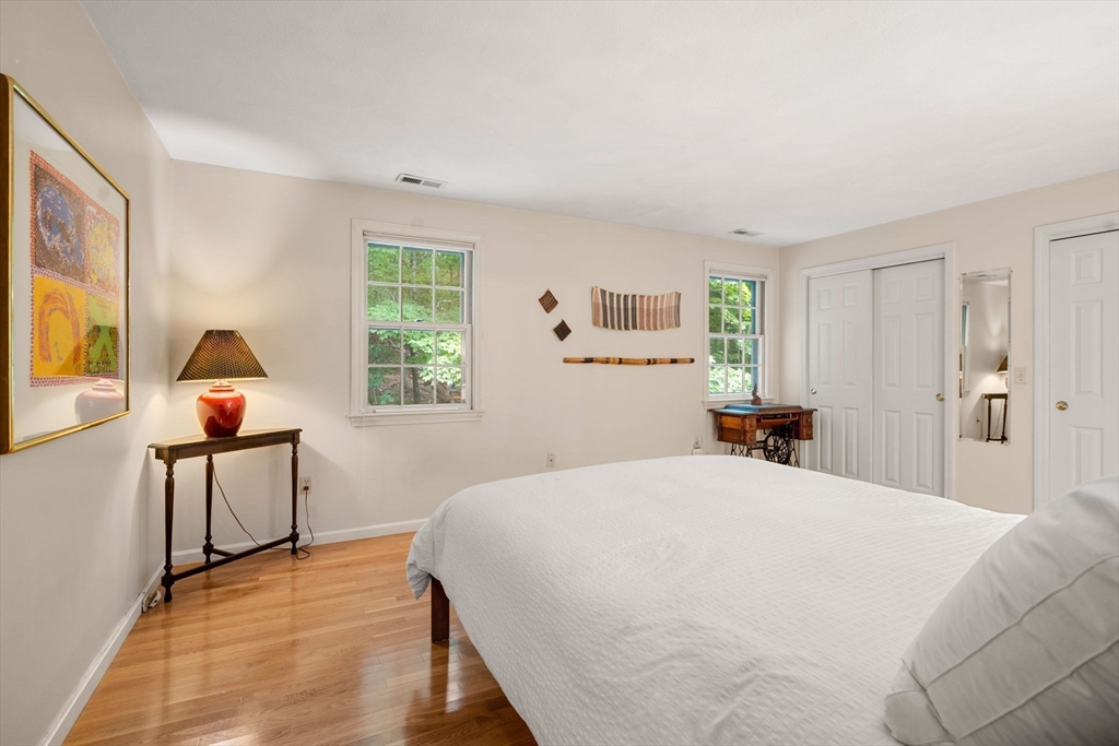 10 Apple Ridge Road, Unit 4 Maynard, MA 01754 - Photo 15 of 27 a bedroom with a bed and a table in it