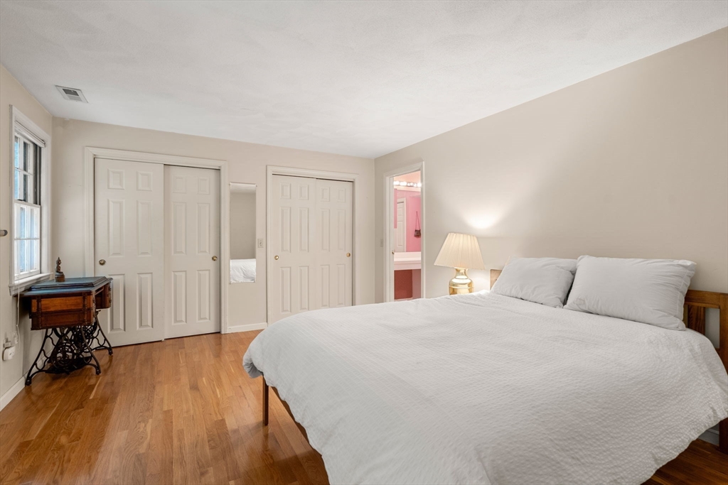 10 Apple Ridge Road, Unit 4 Maynard, MA 01754 - Photo 16 of 27 a bed room with a bed and a chair