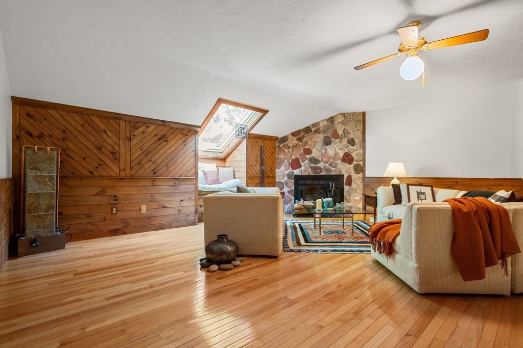 10 Apple Ridge Road, Unit 4 Maynard, MA 01754 - Photo 21 of 27 a view of a livingroom with wooden floor and a fireplace