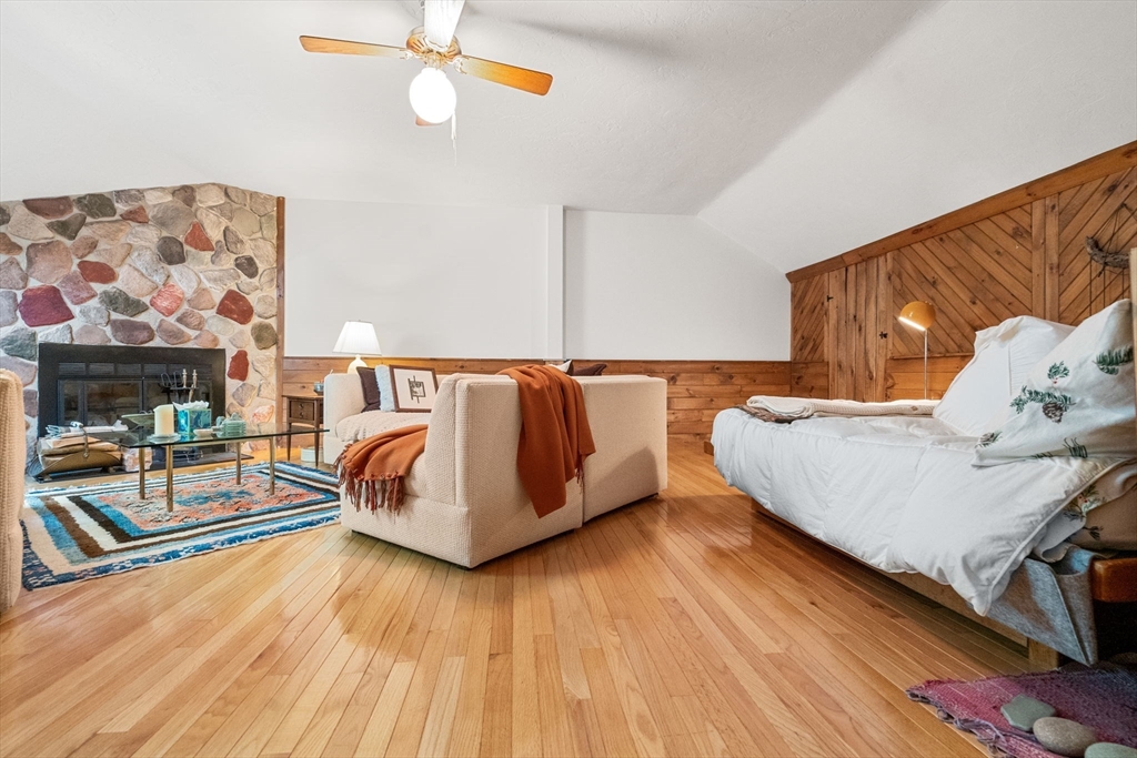 10 Apple Ridge Road, Unit 4 Maynard, MA 01754 - Photo 22 of 27 a bedroom with a bed and wooden floor