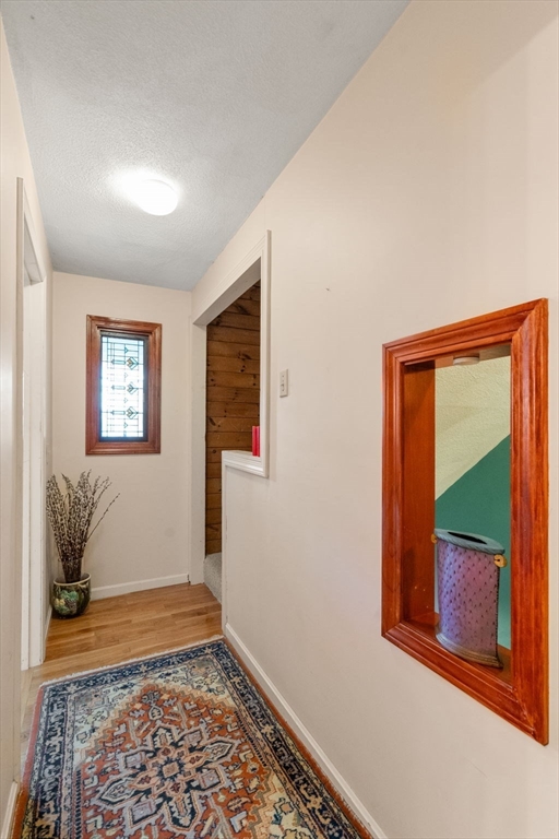 10 Apple Ridge Road, Unit 4 Maynard, MA 01754 - Photo 24 of 27 a room with window and a wooden floor