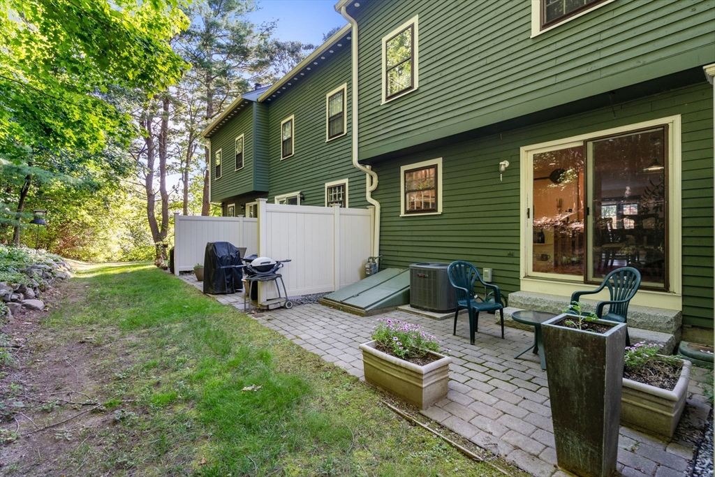 10 Apple Ridge Road, Unit 4 Maynard, MA 01754 - Photo 25 of 27 a view of a house with backyard and sitting area