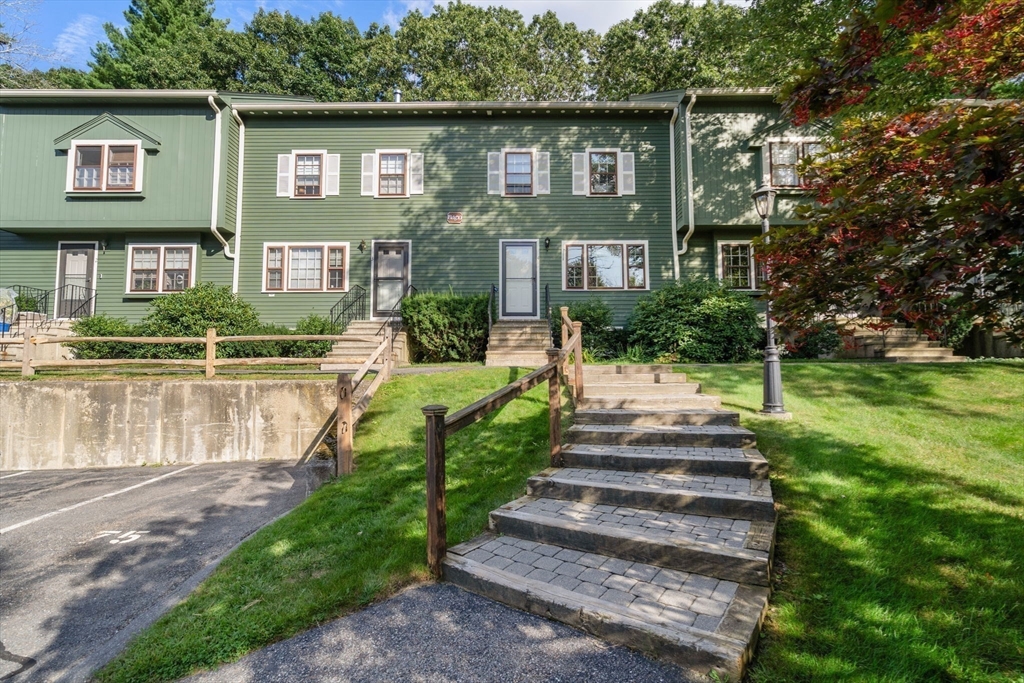 10 Apple Ridge Road, Unit 4 Maynard, MA 01754 - Photo 27 of 27 a front view of a house with a yard table and chairs