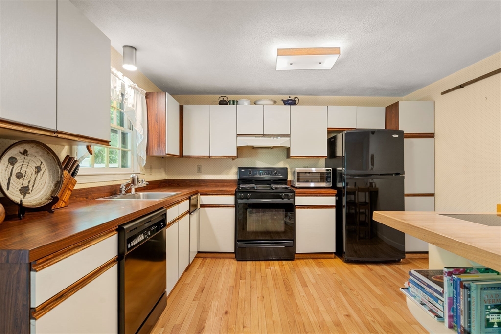 10 Apple Ridge Road, Unit 4 Maynard, MA 01754 - Photo 10 of 27 a kitchen with granite countertop a refrigerator stove and sink