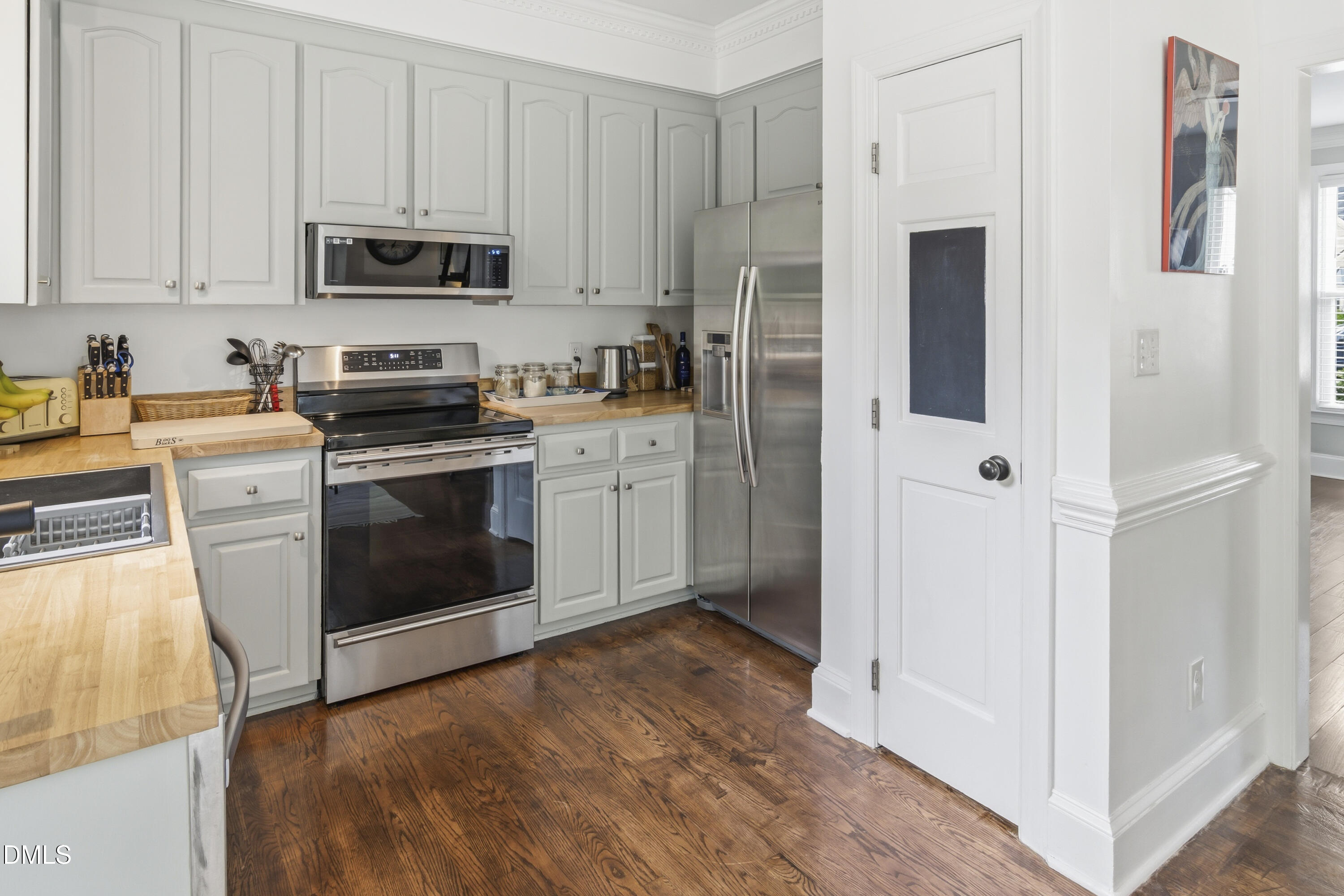 3004 West Annaley Drive Raleigh, NC 27604 - Photo 19 of 44 a kitchen with stainless steel appliances granite countertop a stove a refrigerator and a microwave