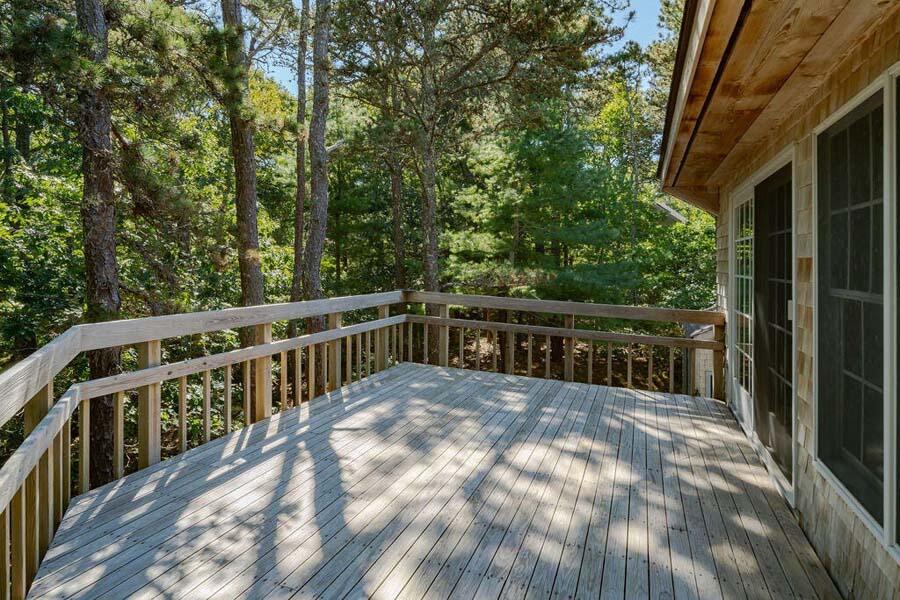 45 Old Long Pond Road Wellfleet, MA 02667 - Photo 20 of 47 a view of balcony with wooden fence and trees