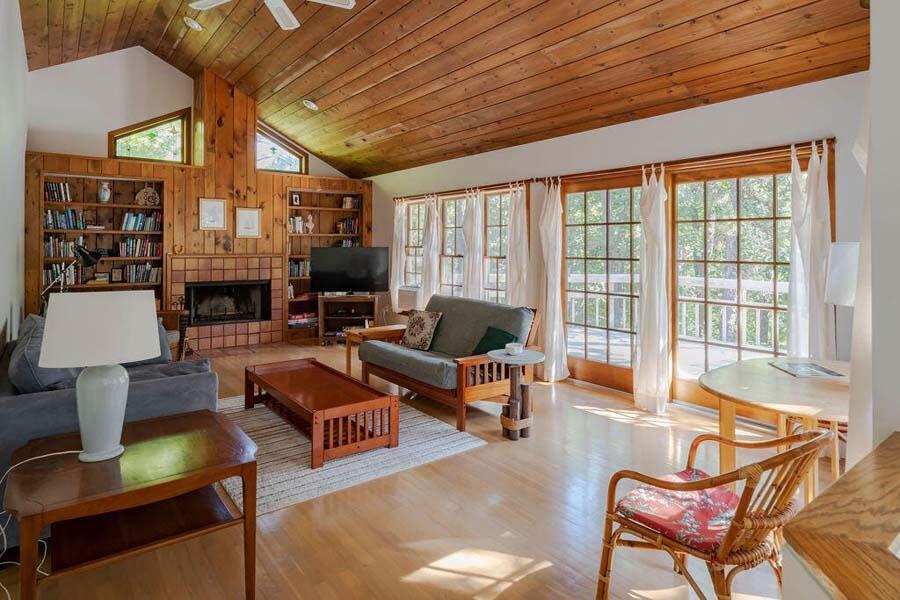 45 Old Long Pond Road Wellfleet, MA 02667 - Photo 2 of 47 a living room with furniture a fireplace and a table
