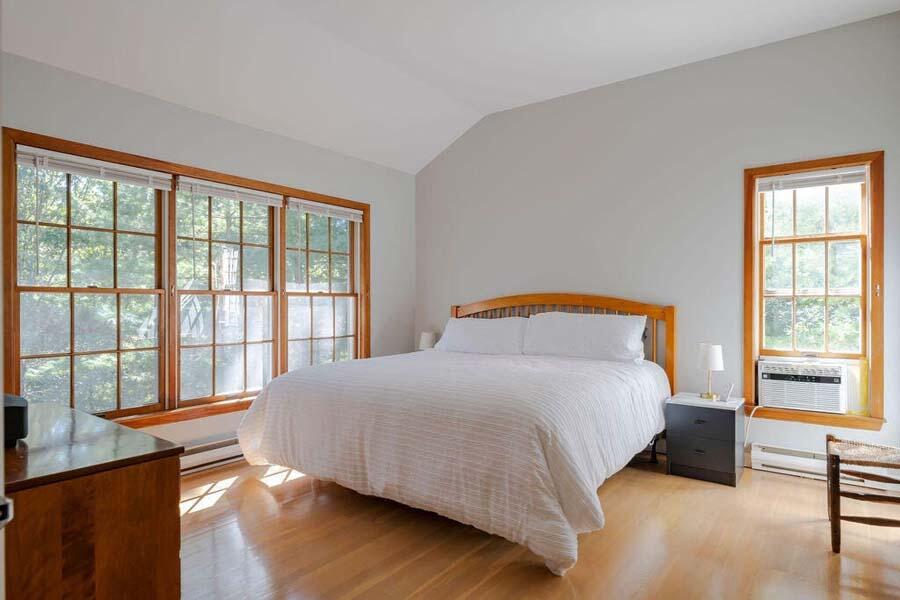 45 Old Long Pond Road Wellfleet, MA 02667 - Photo 22 of 47 a bedroom with a bed and a large window