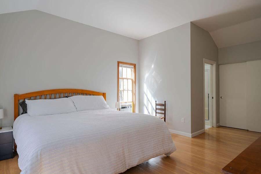 45 Old Long Pond Road Wellfleet, MA 02667 - Photo 23 of 47 a bedroom with a large bed and wooden floor