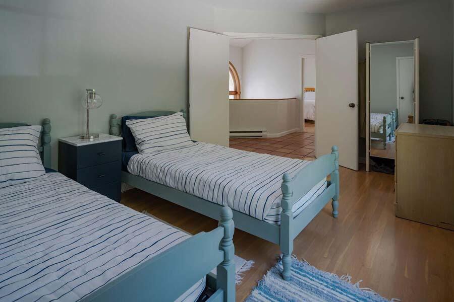 45 Old Long Pond Road Wellfleet, MA 02667 - Photo 29 of 47 a bedroom with a bed and wooden floor