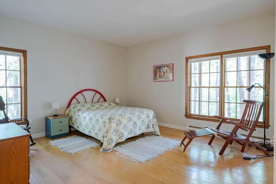 45 Old Long Pond Road Wellfleet, MA 02667 - Photo 30 of 47 a bedroom with a bed and a large window