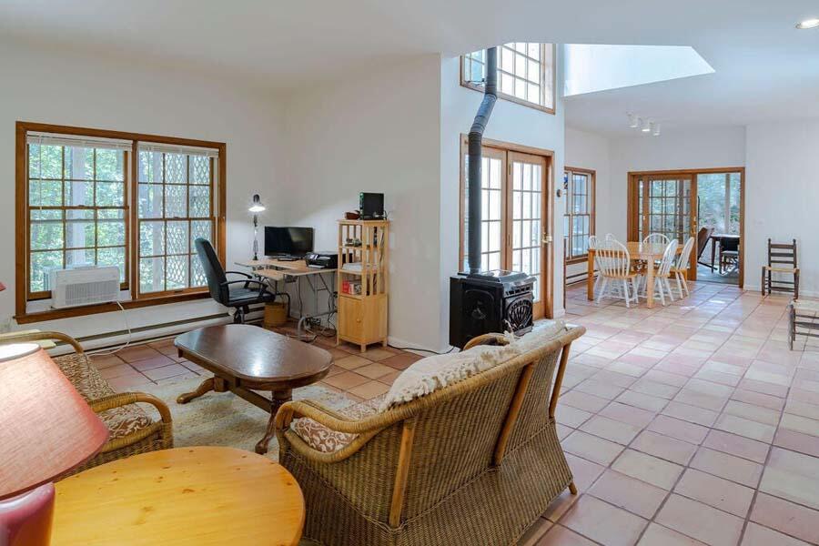 45 Old Long Pond Road Wellfleet, MA 02667 - Photo 5 of 47 a living room with furniture a flat screen tv and a large window