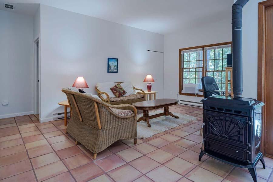 45 Old Long Pond Road Wellfleet, MA 02667 - Photo 6 of 47 a living room with furniture a rug and a window