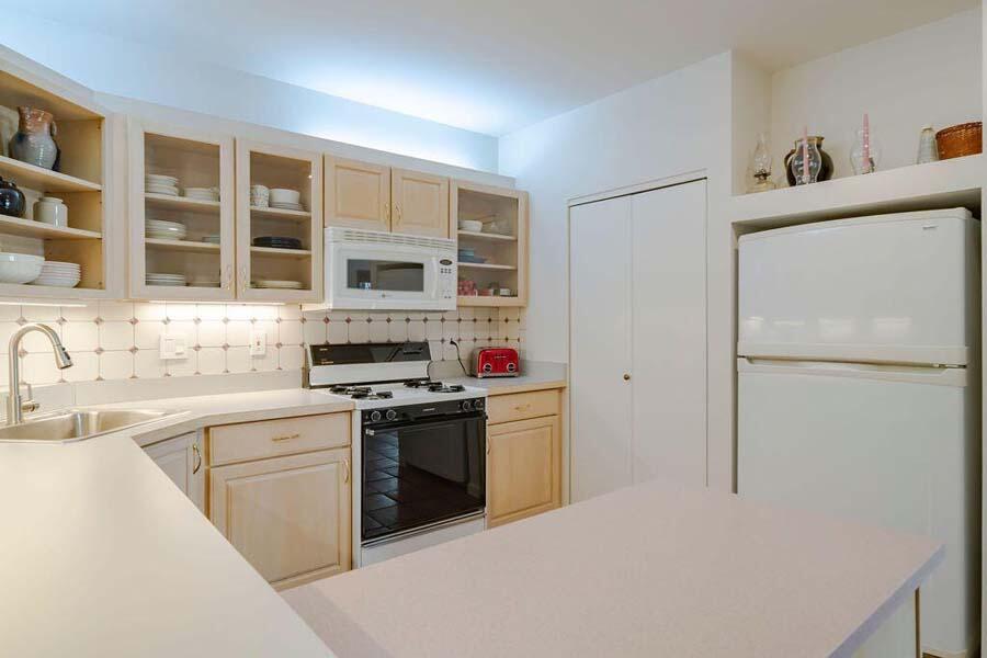 45 Old Long Pond Road Wellfleet, MA 02667 - Photo 10 of 47 a kitchen with cabinets and stainless steel appliances