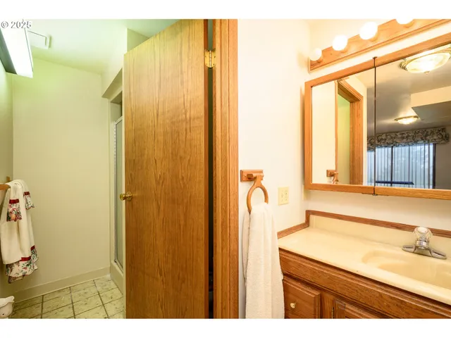 a bathroom with a sink a mirror and a shower