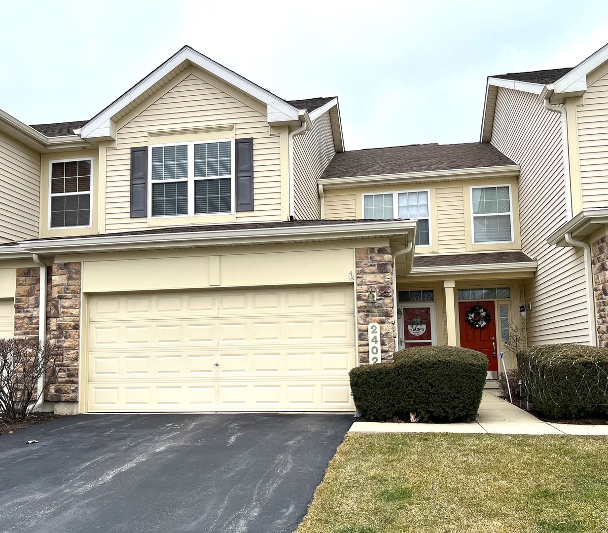 a front view of a house with a yard and garage