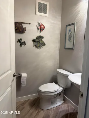 a kitchen with a table chairs refrigerator and cabinets