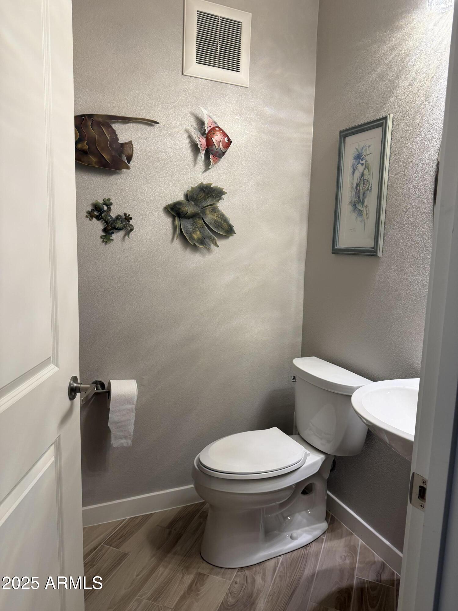 2511 West Queen Creek Road, Unit 223 Chandler, AZ 85248 - Photo 19 of 29 a white toilet sitting next to a bathroom sink