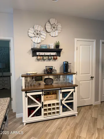 a room with pool table windows and wooden floor