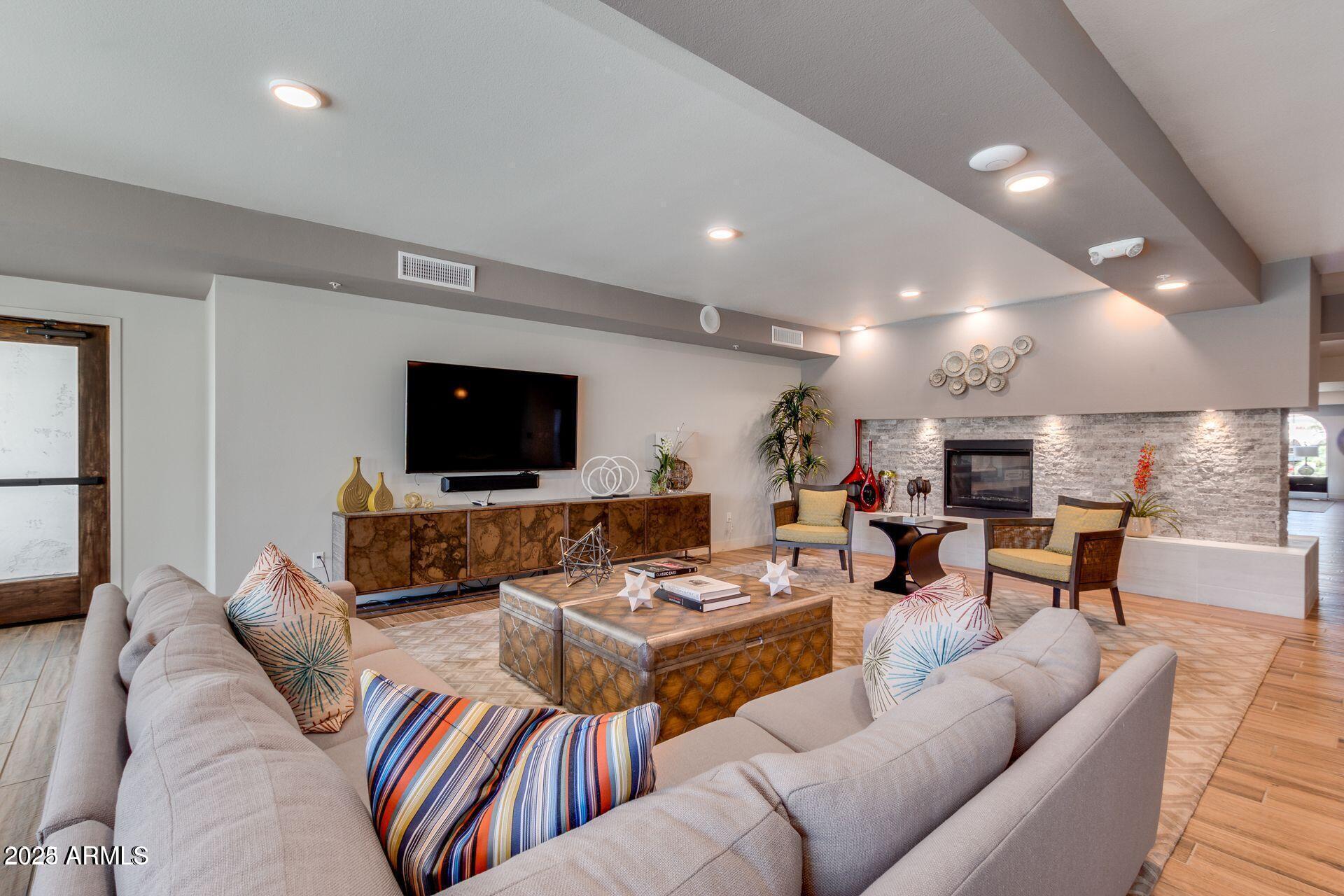 2511 West Queen Creek Road, Unit 223 Chandler, AZ 85248 - Photo 24 of 29 a living room with furniture and a flat screen tv