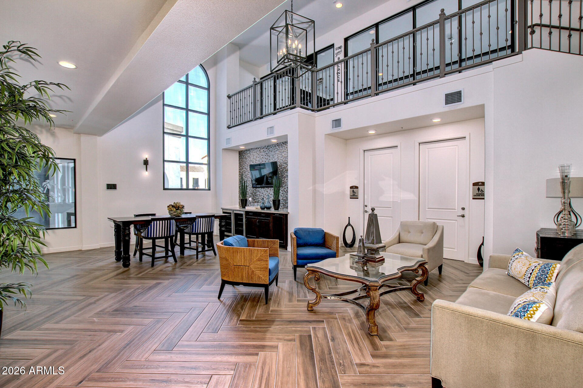 2511 West Queen Creek Road, Unit 223 Chandler, AZ 85248 - Photo 29 of 61 a living room with furniture a chandelier and potted plants