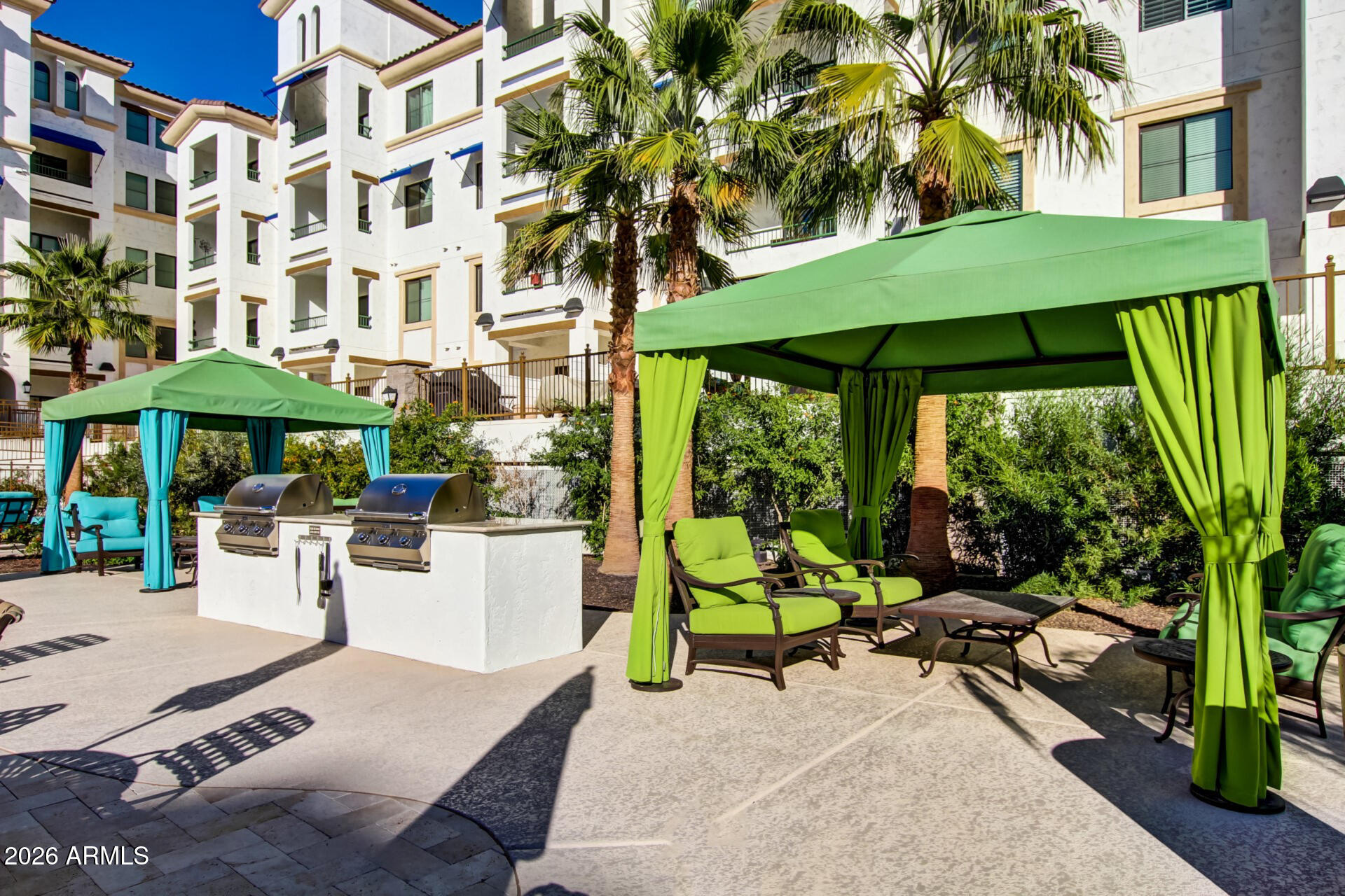 2511 West Queen Creek Road, Unit 223 Chandler, AZ 85248 - Photo 40 of 61 a view of a chairs and table in patio with a small pool