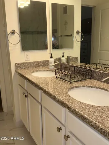a bathroom with a sink and mirror