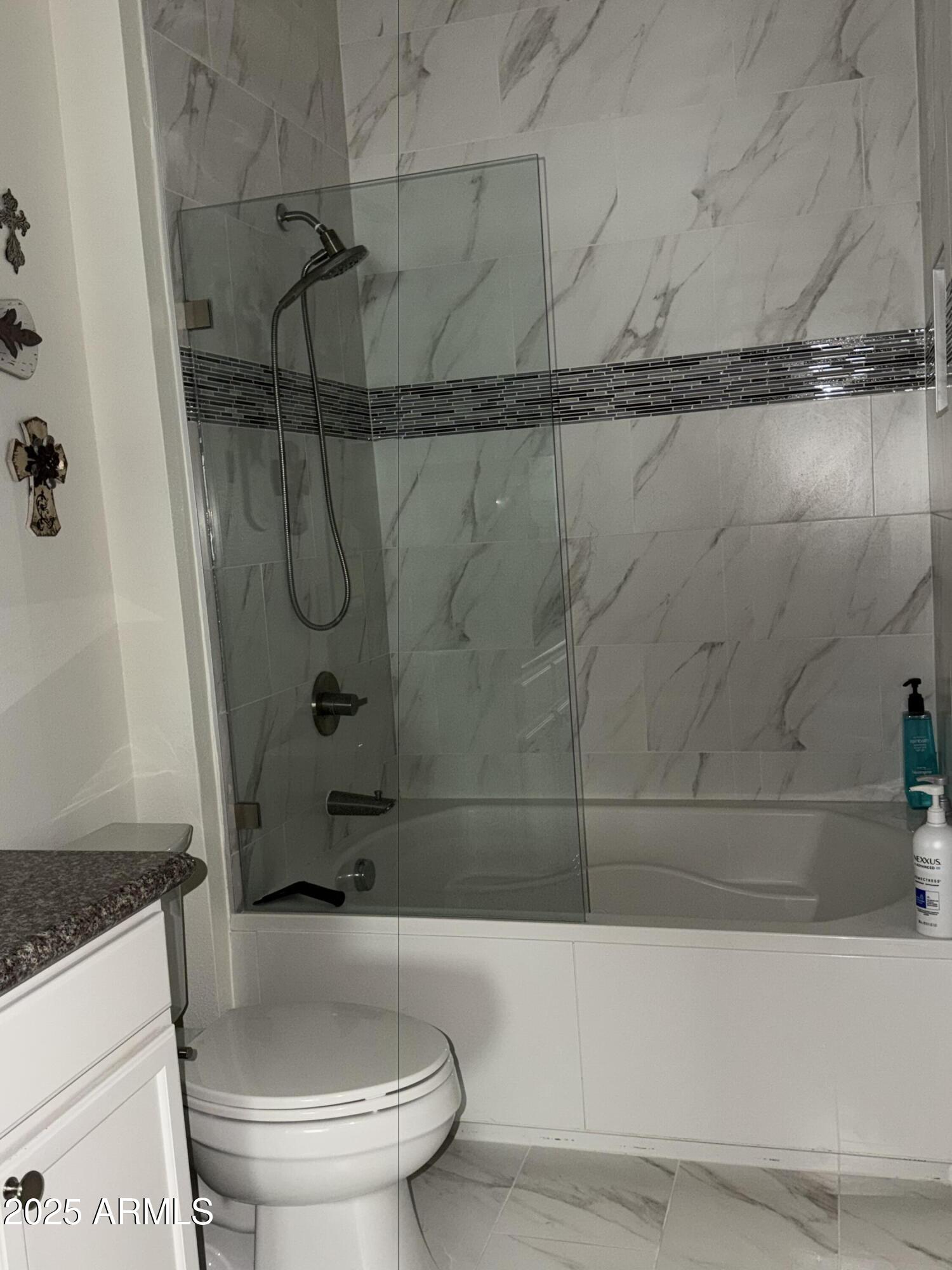 2511 West Queen Creek Road, Unit 223 Chandler, AZ 85248 - Photo 8 of 29 a bathroom with a granite countertop bathtub shower and toilet