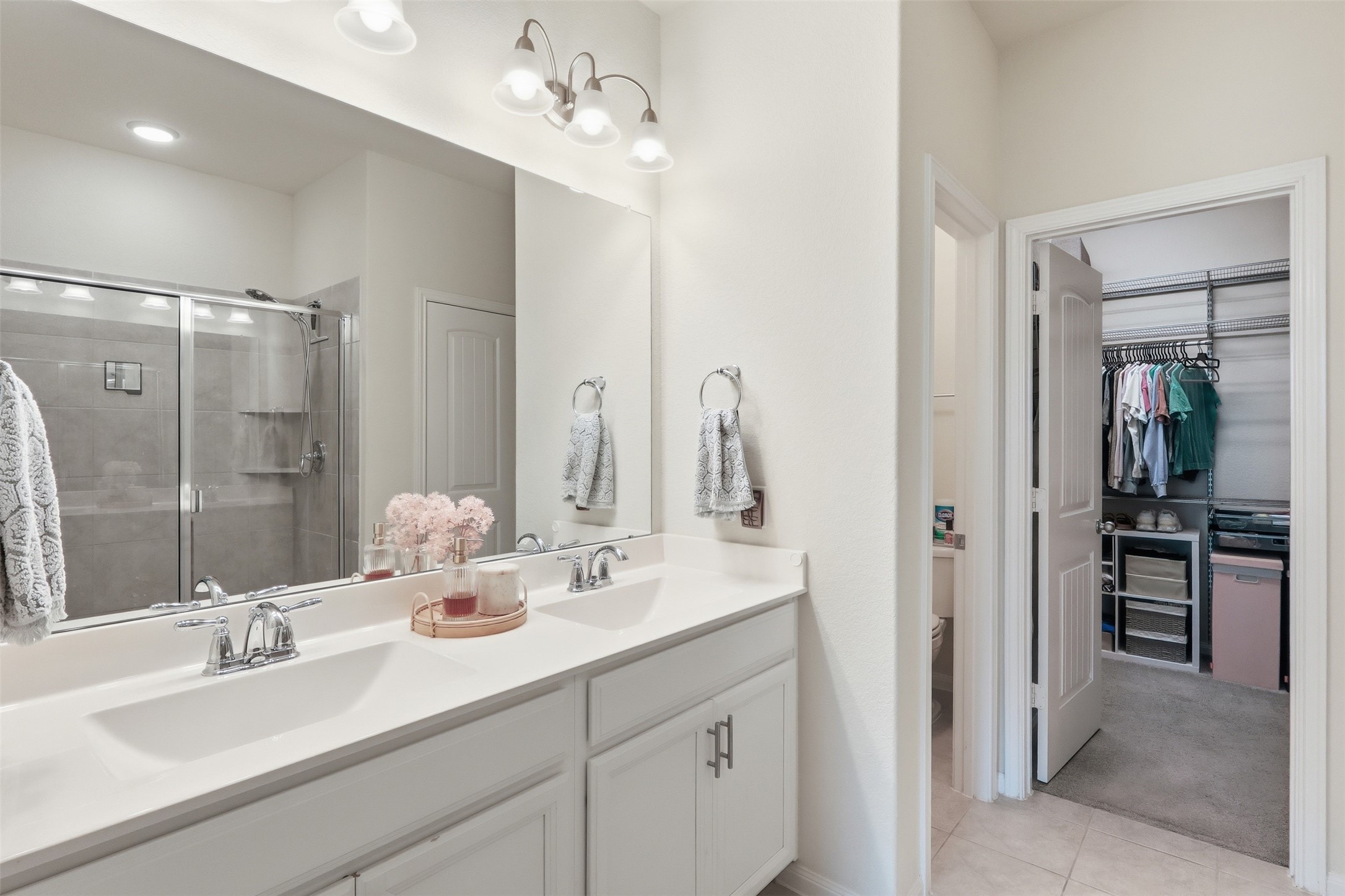 9739 Birdsnest Court Spring, TX 77379 - Photo 18 of 38 Primary bathroom offering one vanity with dual sinks and walk-in shower with large linen closet.
