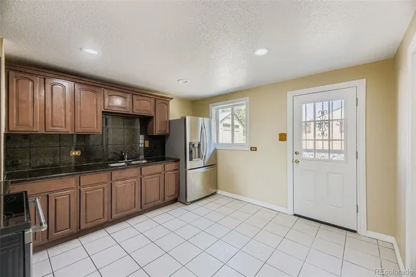 a kitchen with a sink cabinets and window