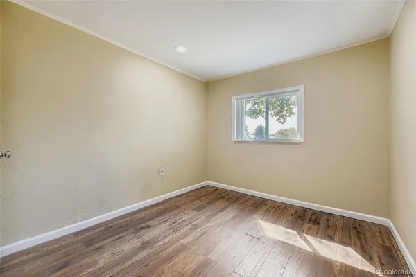 a view of room with window and wooden floor