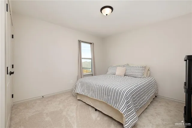 a bedroom with a bed and window