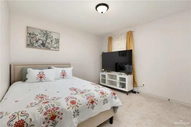 a bedroom with a bed and a flat screen tv