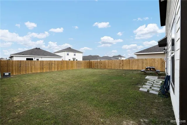 a view of a house with backyard and garden