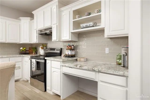 a kitchen with stainless steel appliances granite countertop a sink and cabinets