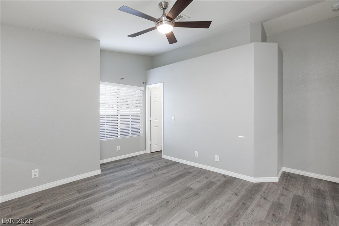2254 Ramsgate Drive Henderson, NV 89074 - Photo 17 of 43 A quiet bedroom featuring resilient flooring and a ceiling fan, offering a tranquil retreat.