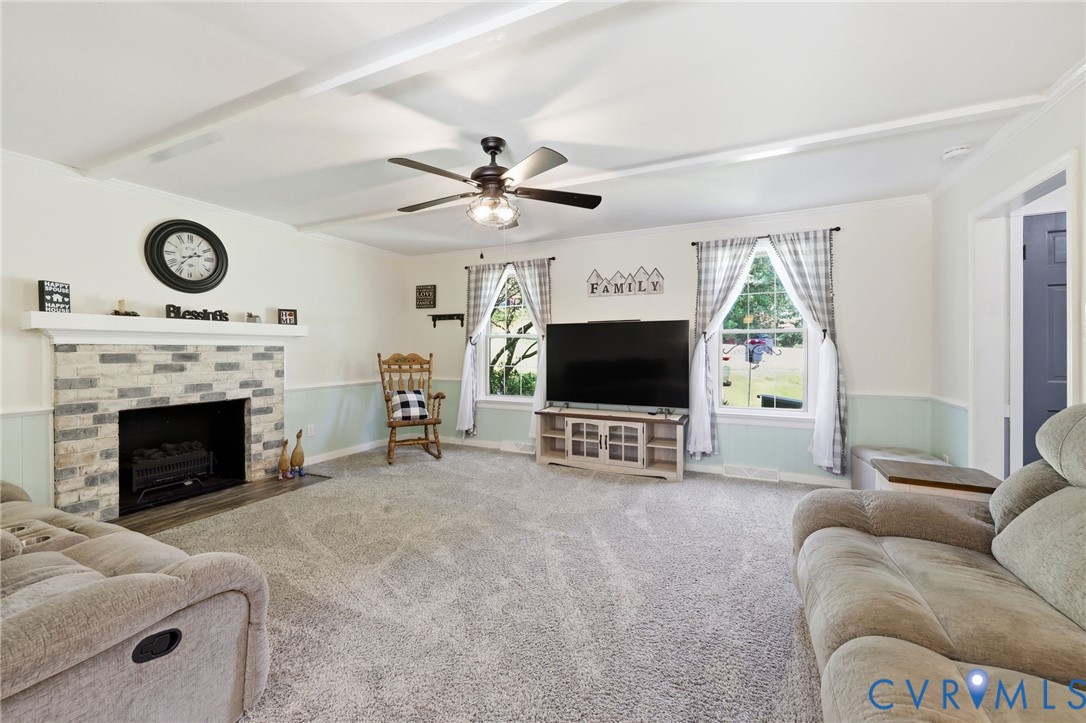 11200 Surry Road Chester, VA 23831 - Photo 9 of 48 a living room with furniture a flat screen tv and a fireplace
