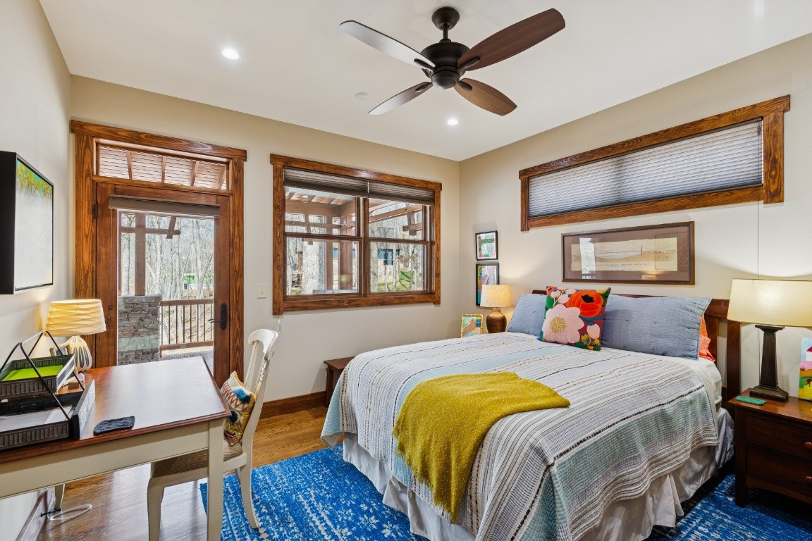 394 Myers Point Road Sewanee, TN 37375 - Photo 21 of 44 a bedroom with a bed a dresser and wooden floor