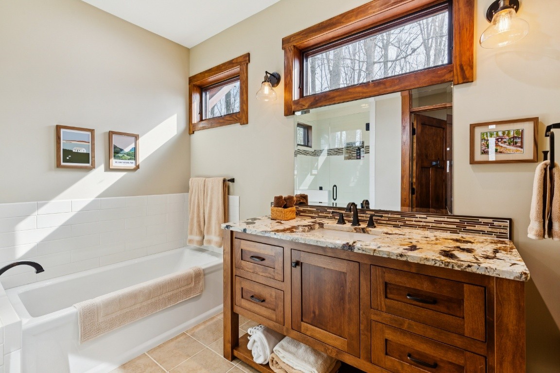 394 Myers Point Road Sewanee, TN 37375 - Photo 24 of 44 a bathroom with a tub a sink and a mirror