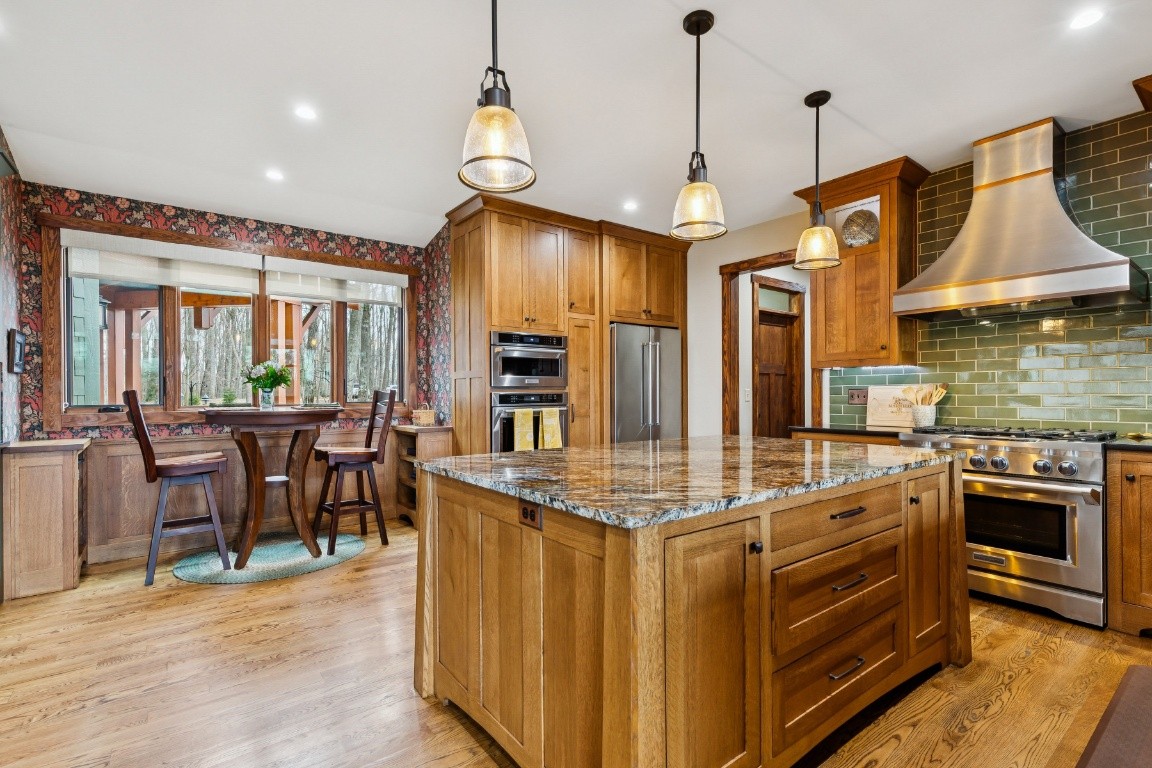 394 Myers Point Road Sewanee, TN 37375 - Photo 10 of 44 a kitchen with stainless steel appliances granite countertop a stove and a wooden floors