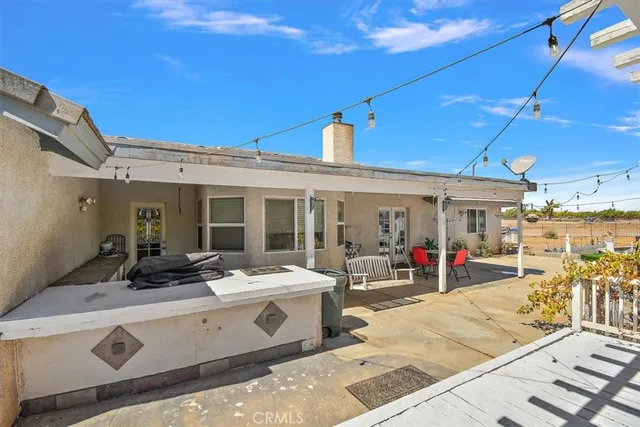 a view of a patio with table and chairs potted plants with wooden fence