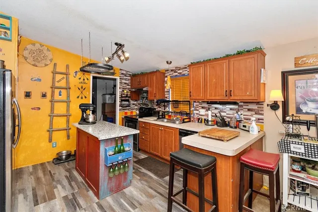 a kitchen with a sink a stove and chairs