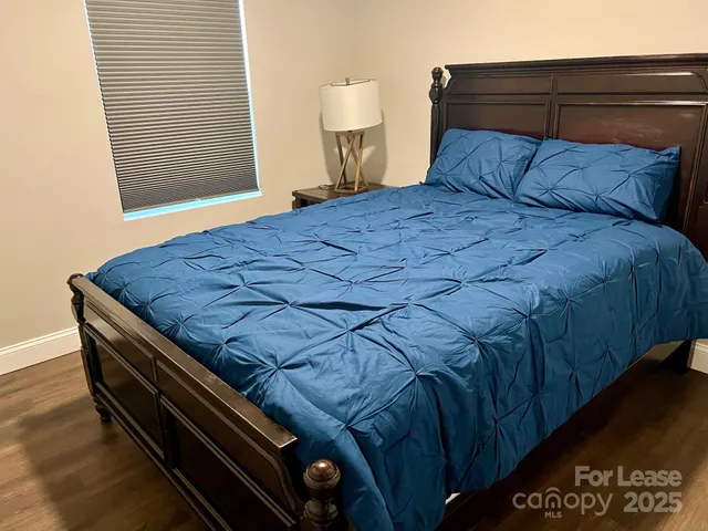 a bed sitting in a bedroom next to a cabinet