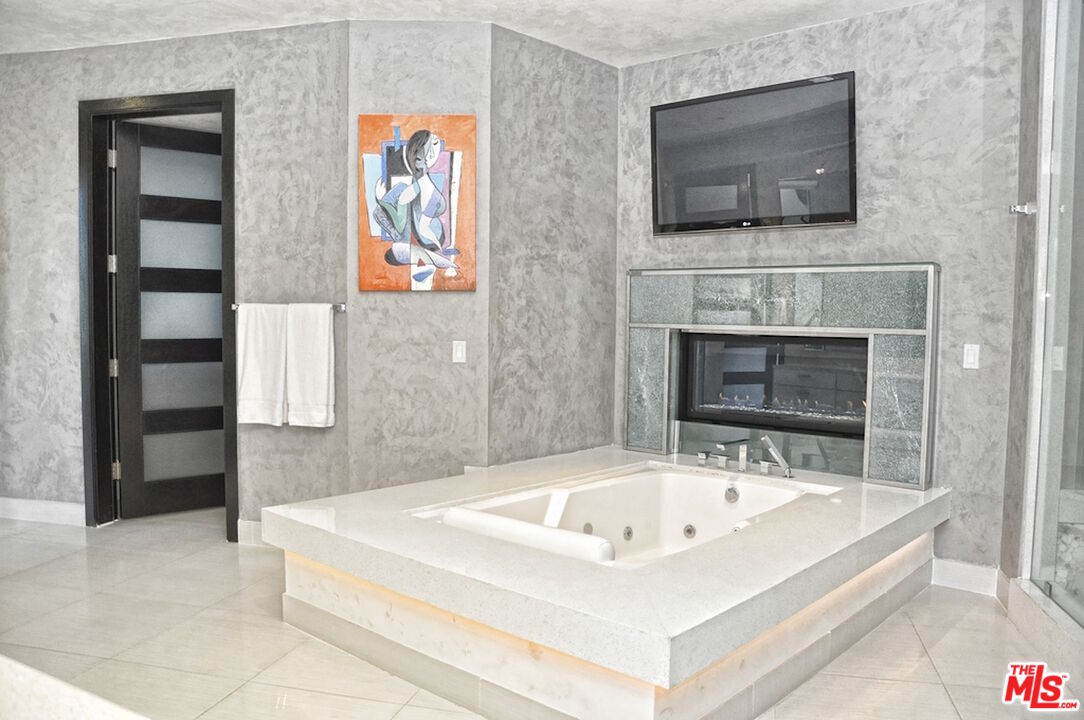 6425 Weidlake Drive Los Angeles, CA 90068 - Photo 16 of 37 a white bath tub sitting in a en suite bathroom