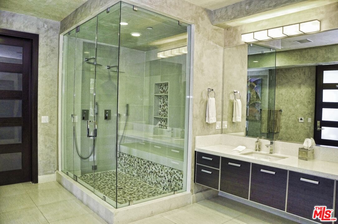 6425 Weidlake Drive Los Angeles, CA 90068 - Photo 19 of 37 a bathroom with a shower sink and mirror